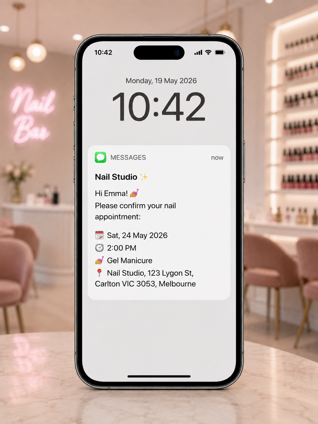 Phone showing a friendly SMS appointment reminder from a salon
